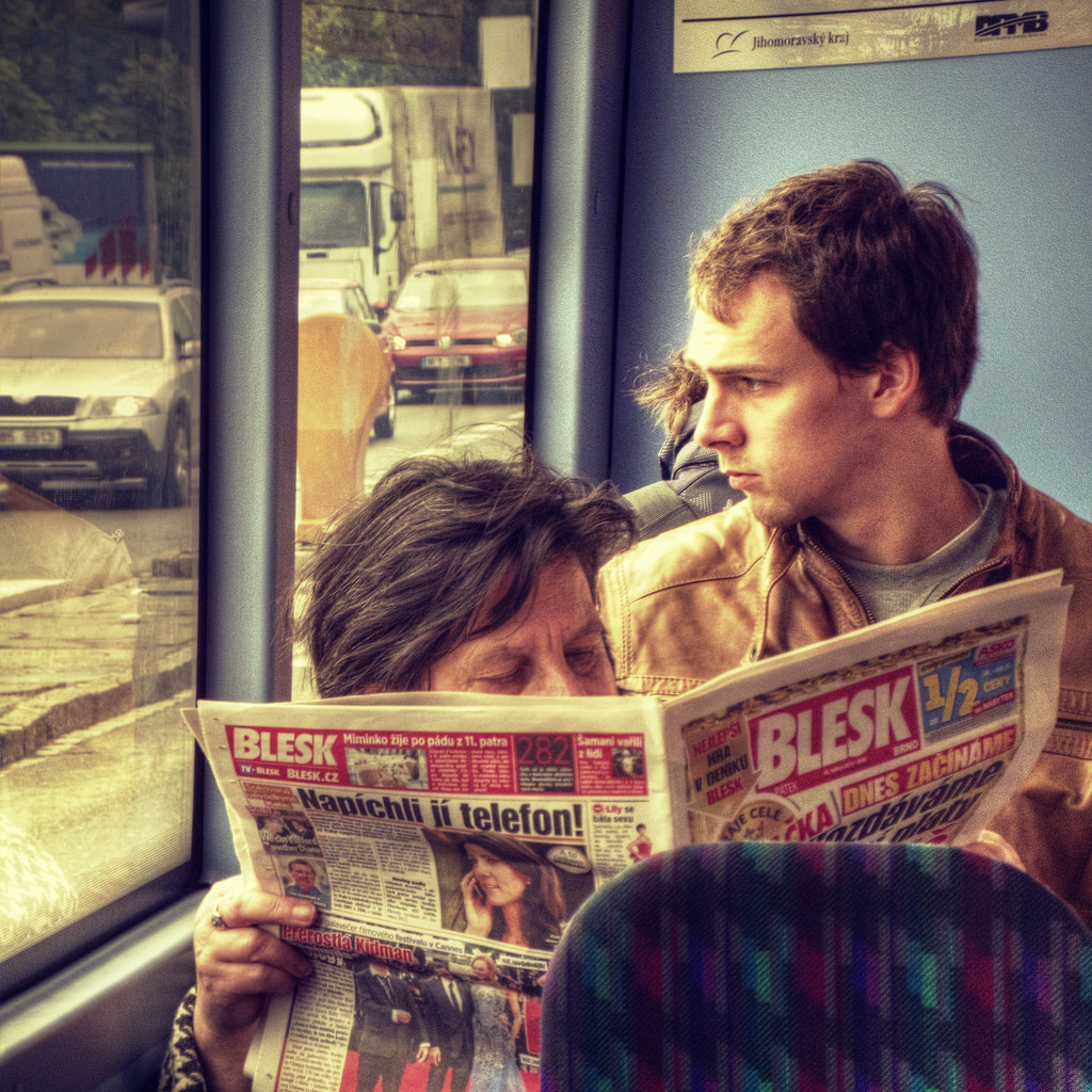 Woman Reading a Tabloid in the Bus 2