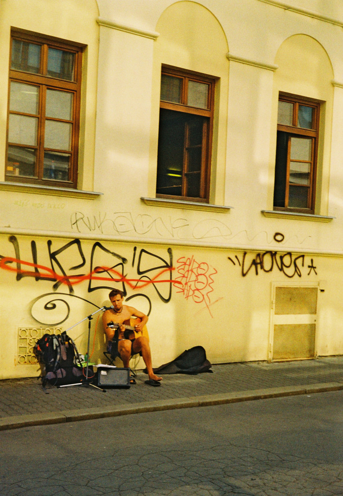 Street Musician under the Scrawl (redscale film)